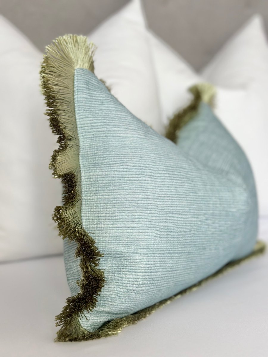 Mist Blue Throw Pillow with Green Brushed Fringe – Luxury designer accent pillow in seaglass blue fabric, featuring soft texture and playful green fringe detail. Perfect for modern decor, coastal interiors, or adding sophistication to sofas, armchairs, and beds.