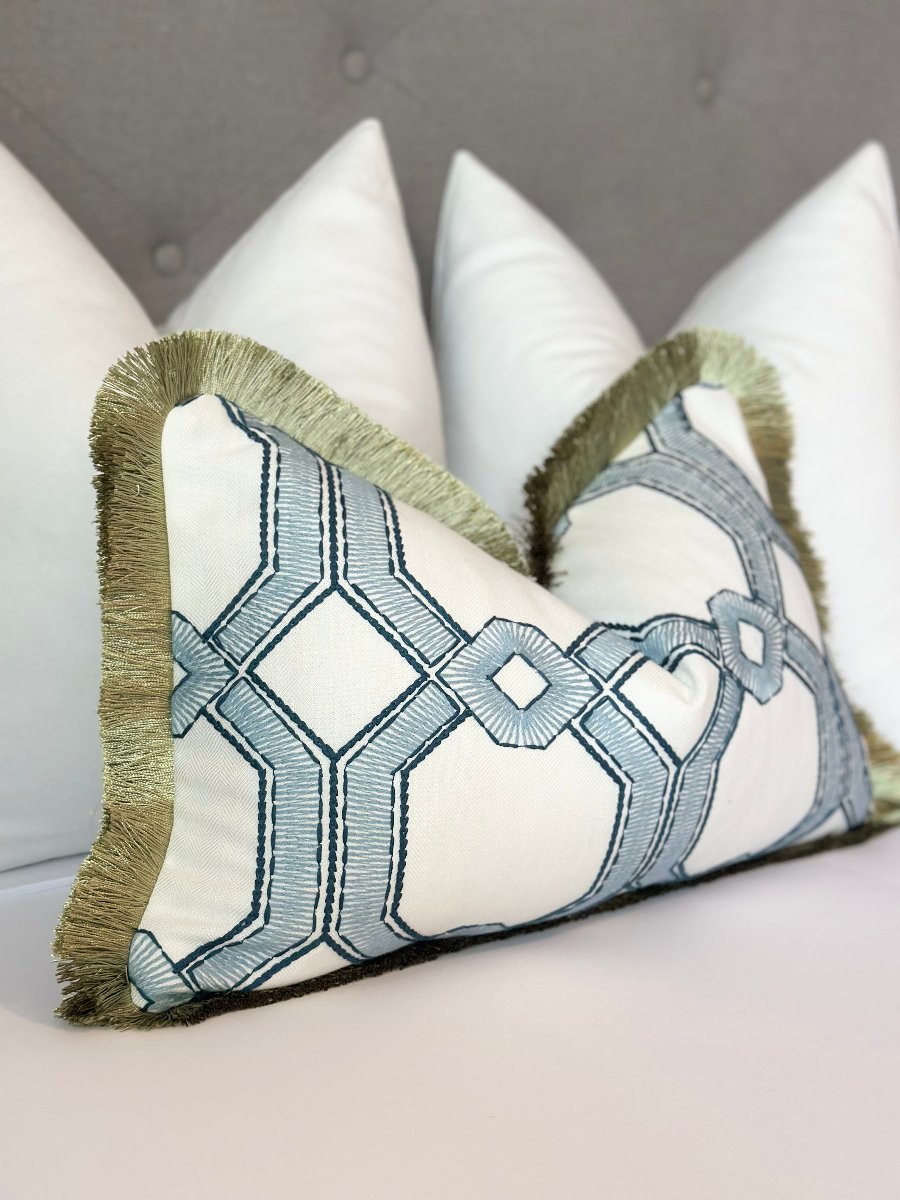 Designer throw pillow with a captivating blue embroidered pattern and chic green thread detailing, crafted from premium designer fabric. This modern pillow features a pristine white background that enhances the intricate embroidery, making it a perfect decorative throw pillow for coastal and modern decor.