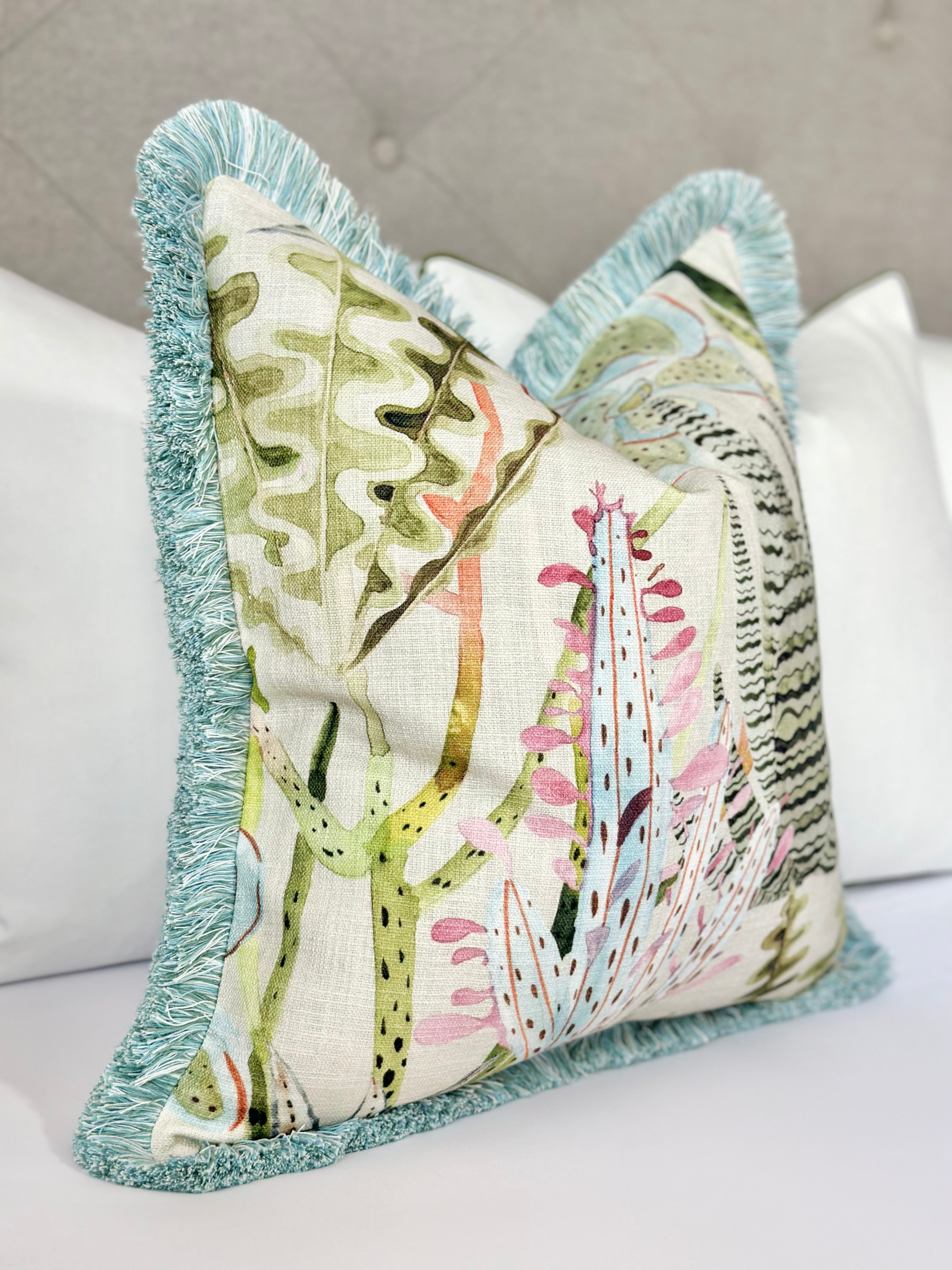 Luxury Pastel Throw Pillow with Light Blue Brushed Fringe and Coral Motifs – Made-to-Order Designer Pillow for Modern and Coastal Decor. Soft Pastel Fabric with Seaglass, Pink, and Green Coral Accents. High-Quality Decorative Throw Pillow for Sofa, Armchair, or Bed, Offering Comfort, Style, and Unique Texture with Modern Elegance.