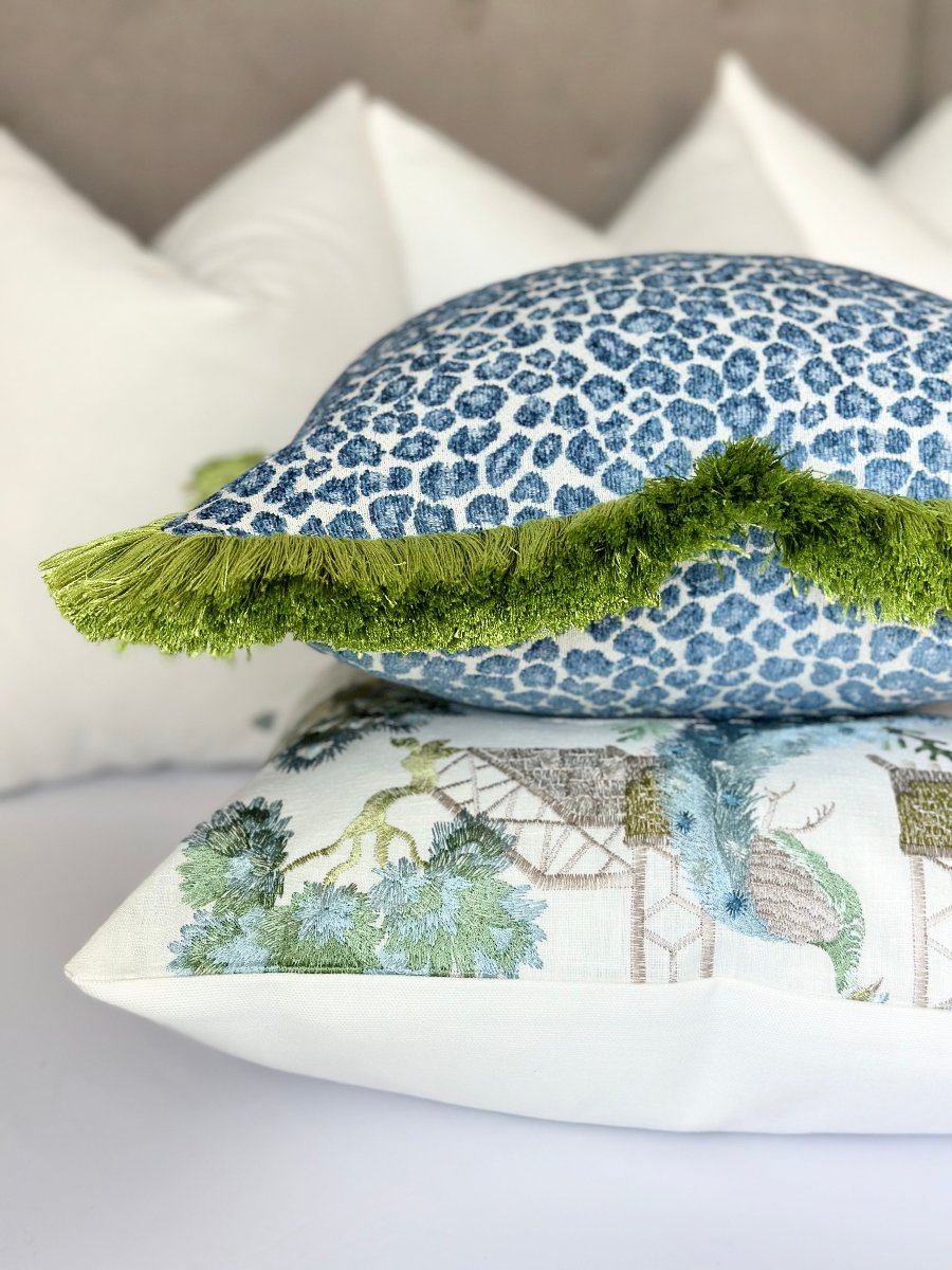 Throw pillow cover featuring a blue cheetah pattern and lush green fringe, perfect for a stylish and unique home decor accent. This custom-made, high-quality pillow cover brings elegance and opulence to any living room or bedroom.