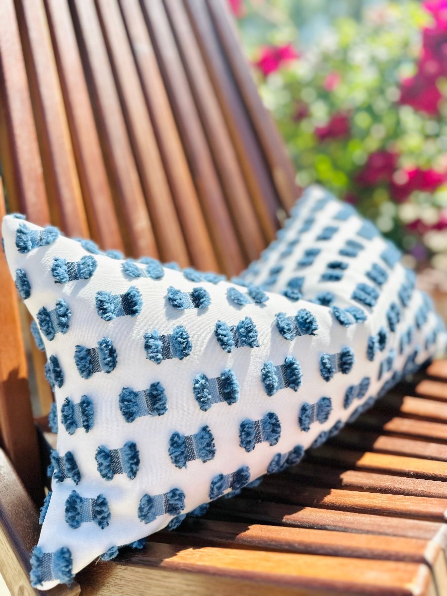 white outdoor pillow, blue fluffy accent pillow, modern coastal decor, custom-made patio cushion, poolside seating pillow, chic coastal vibe, refined outdoor decor, luxury outdoor pillow, serene outdoor atmosphere, modern coastal home accent