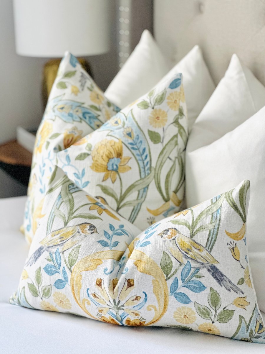 Custom-made floral throw pillow cover featuring delicate birds in flight, with a harmonious blend of blue, green, and mustard yellow on a white background. This designer pillow adds elegance, color, and nature-inspired charm to modern or coastal decor.