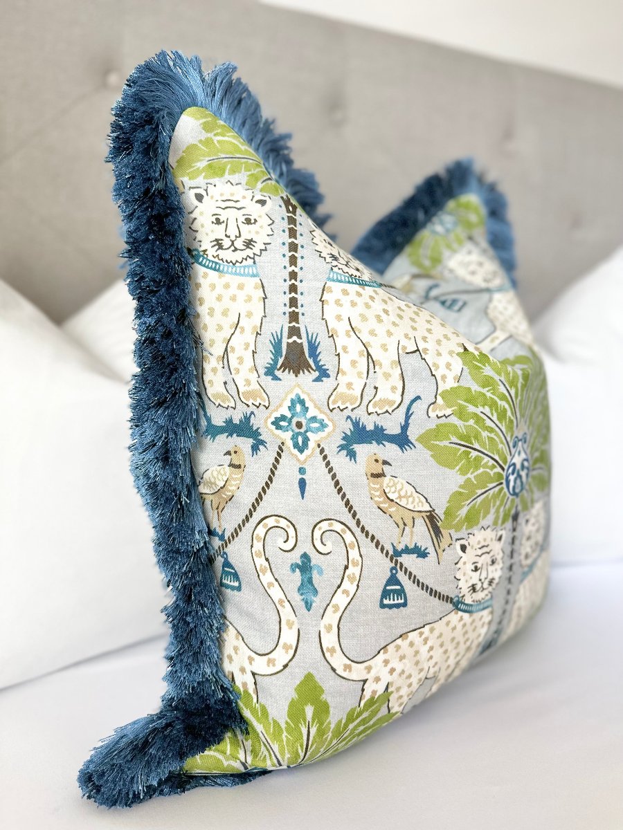 High-quality designer fabric throw pillow cover with a cheerful jaguar pattern and sophisticated navy blue fringe, perfect for a distinctive touch in any room. Custom-made designer accent pillow with exotic jaguar and palm tree print, navy blue brushed fringe.