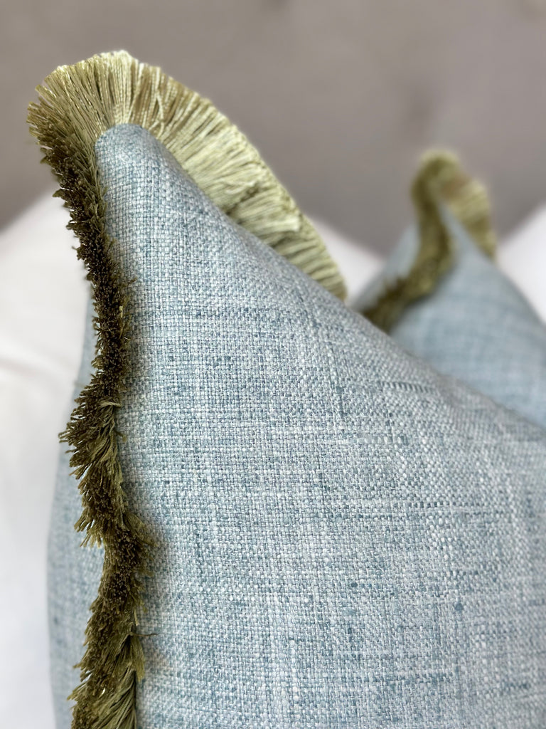 Mist blue cotton pillow green fringe detail