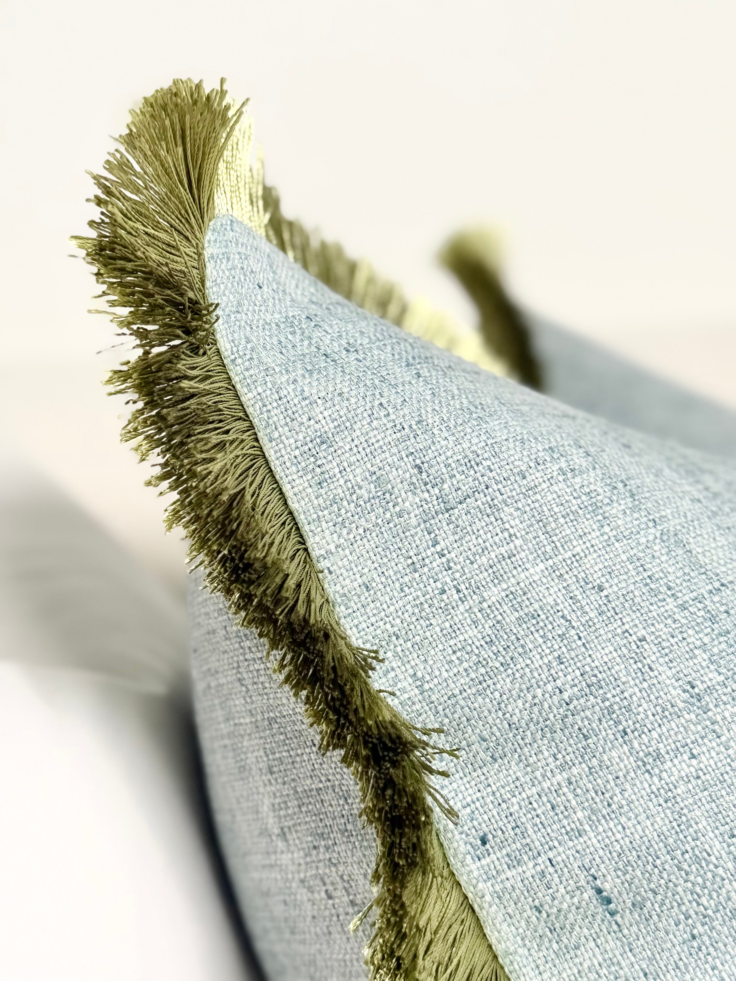 Mist blue cotton pillow green fringe detail